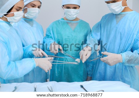 Medical team performing operation. Focus at male doctor 