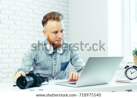 Photographer selecting photos on his computer
