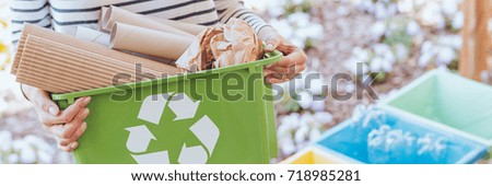 Eco-friendly person taking care of ecosystem by sorting paper to green container. Recycling concept