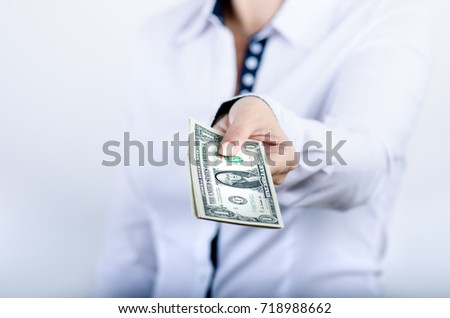 Businesswoman holding dollar banknotes isolated on a white background.Money in women's hands. American currency. One dollar banknotes