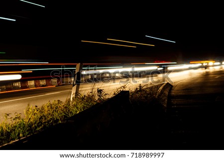 The passing lights of cars and trucks at night