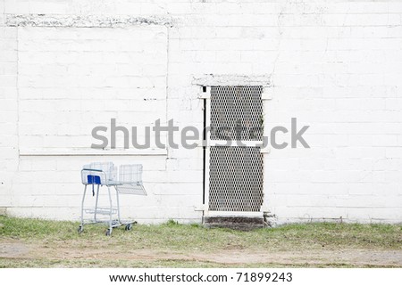 abandoned white wall with shopping cart
