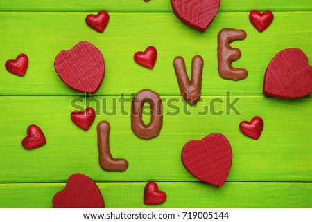 Love written by chocolate cookies alphabet with red hearts