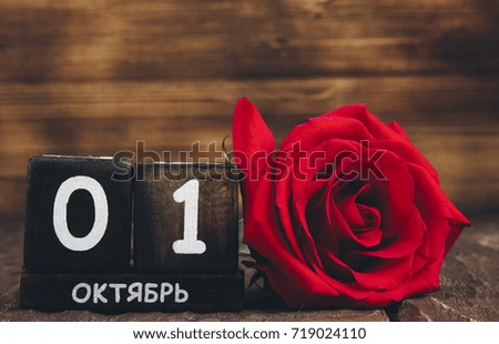 October 1 , flowers on wooden background