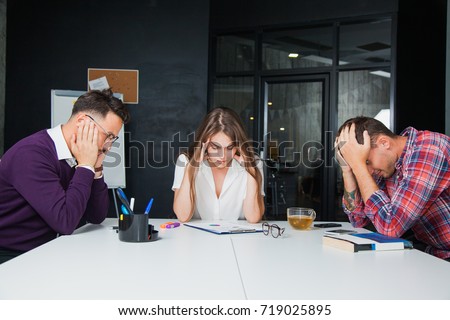 Brainstorming in difficult business situation office workers colleagues. Three young people think hard. Teamwork concept Royalty-Free Stock Photo #719025895