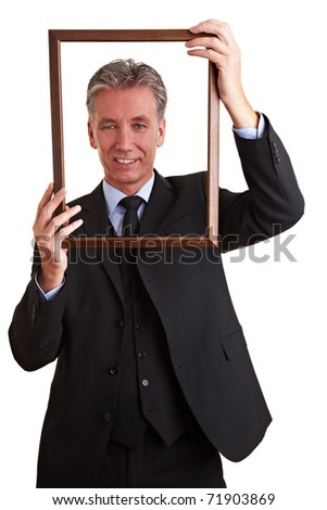 Smiling senior business man looking through empty frame