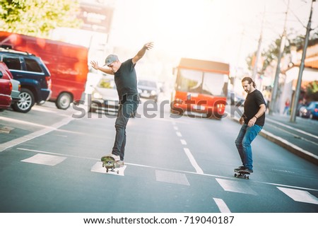 Two professional skateboarders riding skateboard slope on the capital city streets