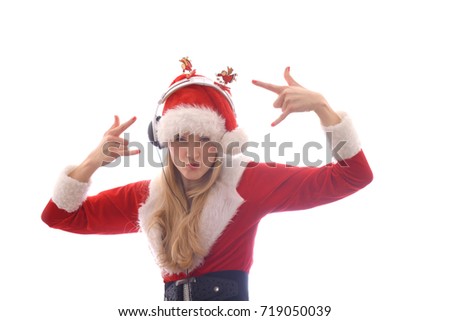 A young girl dresses up as Santa Claus and wants to hear Christmas music.
She wears headphones on her head and shouts and yells out the songs she
hears.