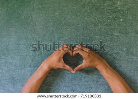 Make hands to be a sign of love on the backboard.symbol of love.