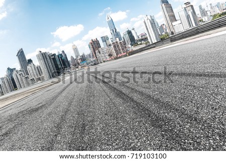 empty asphalt road with cityscape of shanghai in blue sky