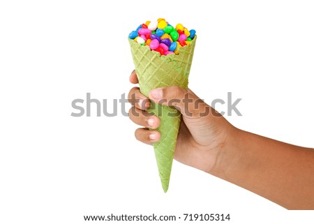 Hand holding ice cream cone on white background