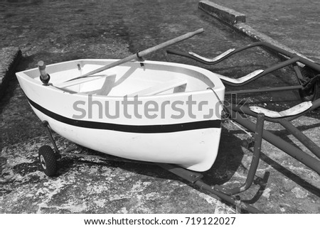 Boat on the trolley for launching on the water. The Inland Sea is a lagoon of seawater on the island of Gozo linked to the Mediterranean Sea through a narrow natural arch. Black and white picture