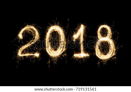 isolated 2018 written with Sparkle firework on black background, happy new year 2018 concept. Royalty-Free Stock Photo #719131561