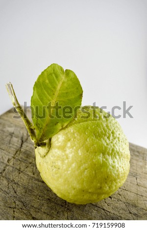 Fresh whole bergamot fruits on wooden.  Also known as "Dayap" or "Lime"