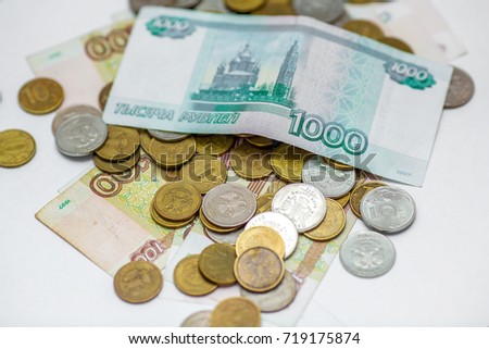 various russian banknotes on a coins background. paper and metal money for illustration
