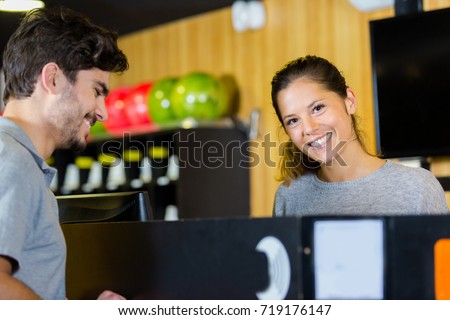 bowling front desk officer speaking with female customer