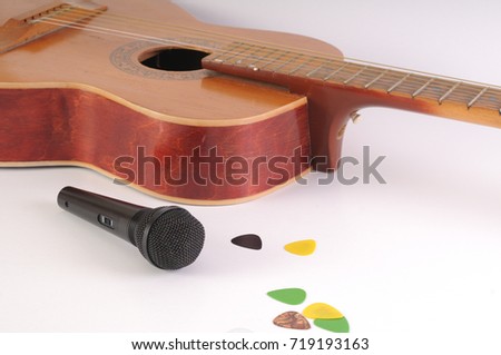 Guitar and microphone on a white background