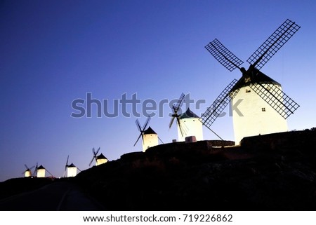 Winds stands on hilltop enjoying the peaceful twilight moment, Consuegra, Spain