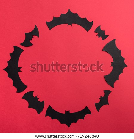 Traditional halloween symbols of black bats on red background. Halloween picture and frame for logo