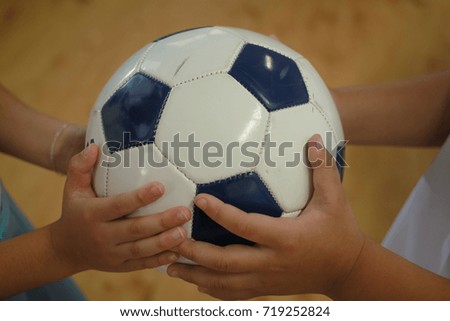 Hands Holding Together Soccer Ball 
