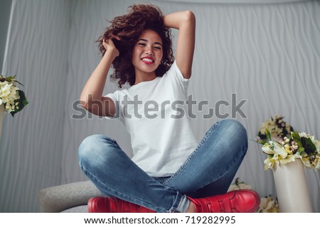 Curly haired girl with freckles in blank white t-shirt. Mock up. Royalty-Free Stock Photo #719282995