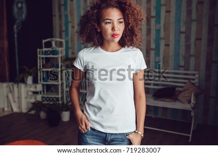 Curly haired girl with freckles in blank white t-shirt. Mock up. Royalty-Free Stock Photo #719283007