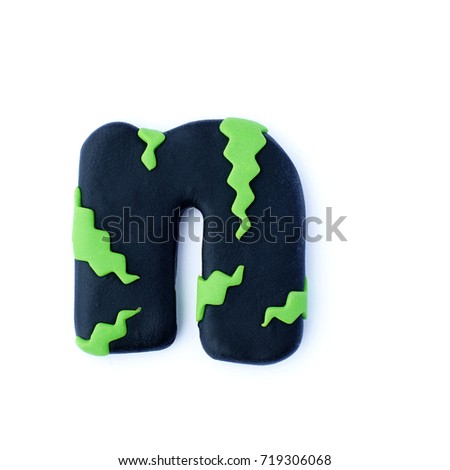 3d black lime green text word letter N isolated on white background. Cute cartoon figures handmade handicraft for clay