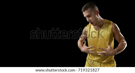 Basketball player on a black background. Isolated happy after victory basketball player in unbranded clothes.