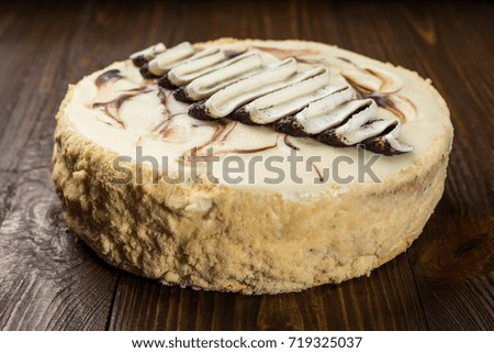 Delicious vegan chocolate cake with cream and poppy seeds on dark wooden background closeup