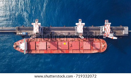 Bulk carrier docked in a Mediterranean port - Top down aerial view Royalty-Free Stock Photo #719332072