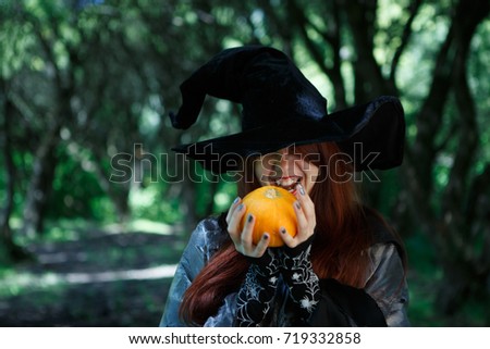 Image of smiling witch with pumpkin