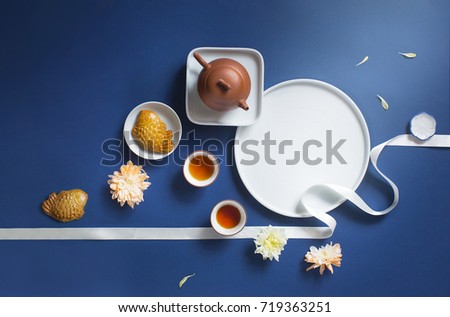 Conceptual flat lay mid-autumn festival food and drink still life. Translation on text in image: Mid-autumn. Royalty-Free Stock Photo #719363251