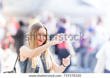 Pretty teenager taking a selfie with her mobile phone outdoor in the city