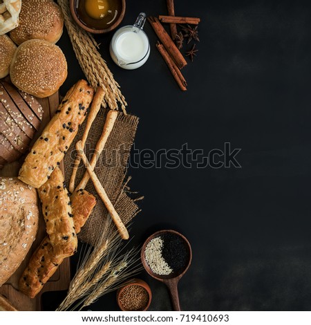 Group of different types of bread on black background, Leave space for text input.