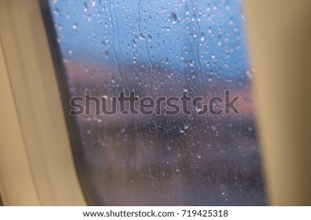 Raindrop on airplane window.