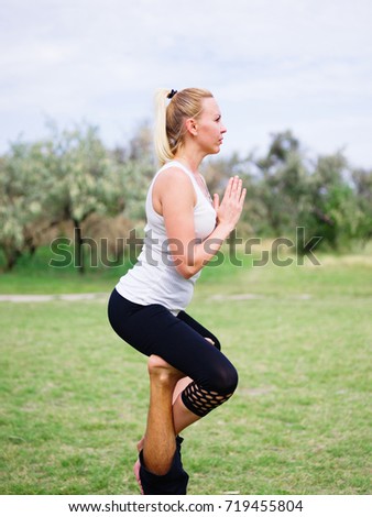 Photo of practicing yoga outdoor. Doing yoga fitness. Exercise for relax and healthy body.