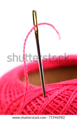 Colored thread, needles on a white background