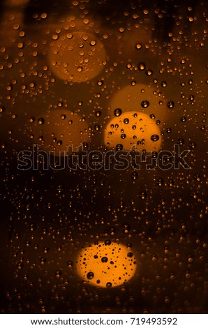 Rain drops on windows with abstract lights