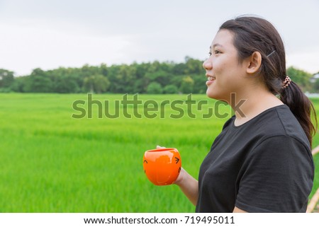 Asian Teen fat women side view hold mug with green nature background fresh nature healthy drink concept