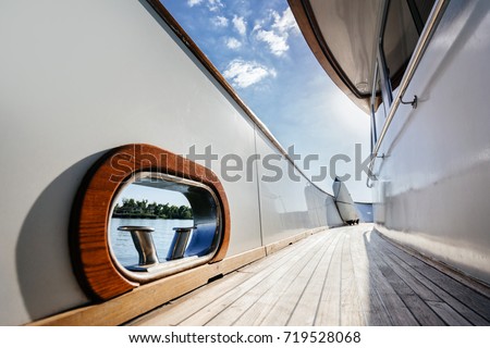 Fairlead and bollard on the deck of a luxury wooden yacht. walk around the ship. Royalty-Free Stock Photo #719528068