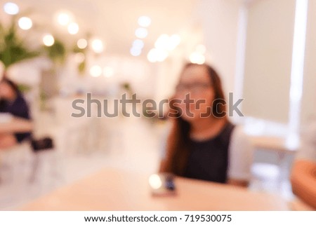 Blurred image of The people sitting and working in coffee shop.