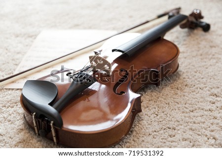 violin on carpet floor with music note