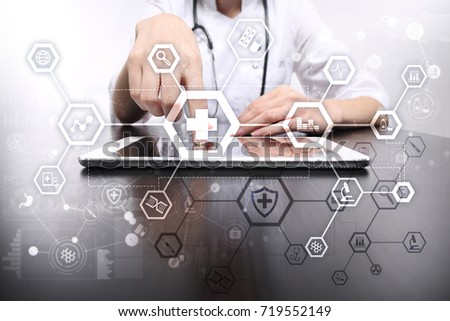 Medical doctor working with modern computer virtual screen interface. Medicine technology and healthcare concept.