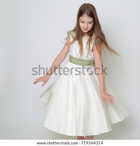 Gorgeous teen girl in a dress posing for a studio portrait/Teen girl dance in motion