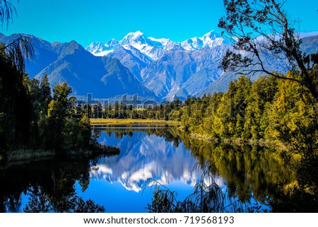 Lake Matheson with Aoraki Mt. Cook Mirror in Fox Glacier, South New Zealand. Royalty-Free Stock Photo #719568193