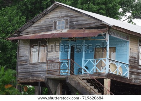 Typical elevated wooden and colored house in Caribbean islands.