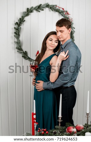 A warm picture of a family couple hugging happily, Christmas atmosphere in a lighted room.