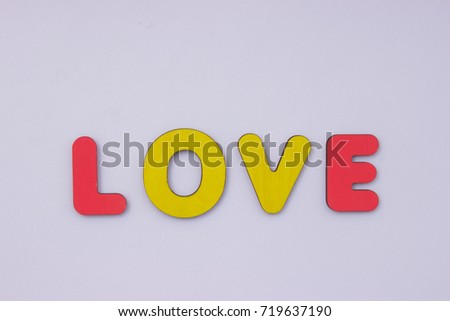 Word Love from wooden letters on light grey background. Happy Valentines Day
