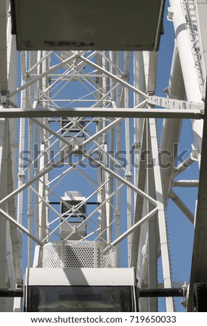 metal structures of the attraction Ferris wheel in the park. the picture is taken at a height