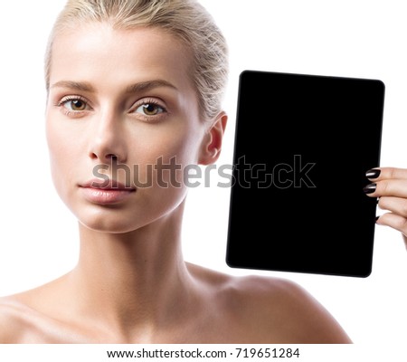 Young beautiful woman shows a black tablet. Portrait isolated on white background